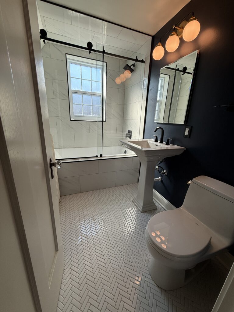 Bathroom remodel with white tile and glass shower in Chicago